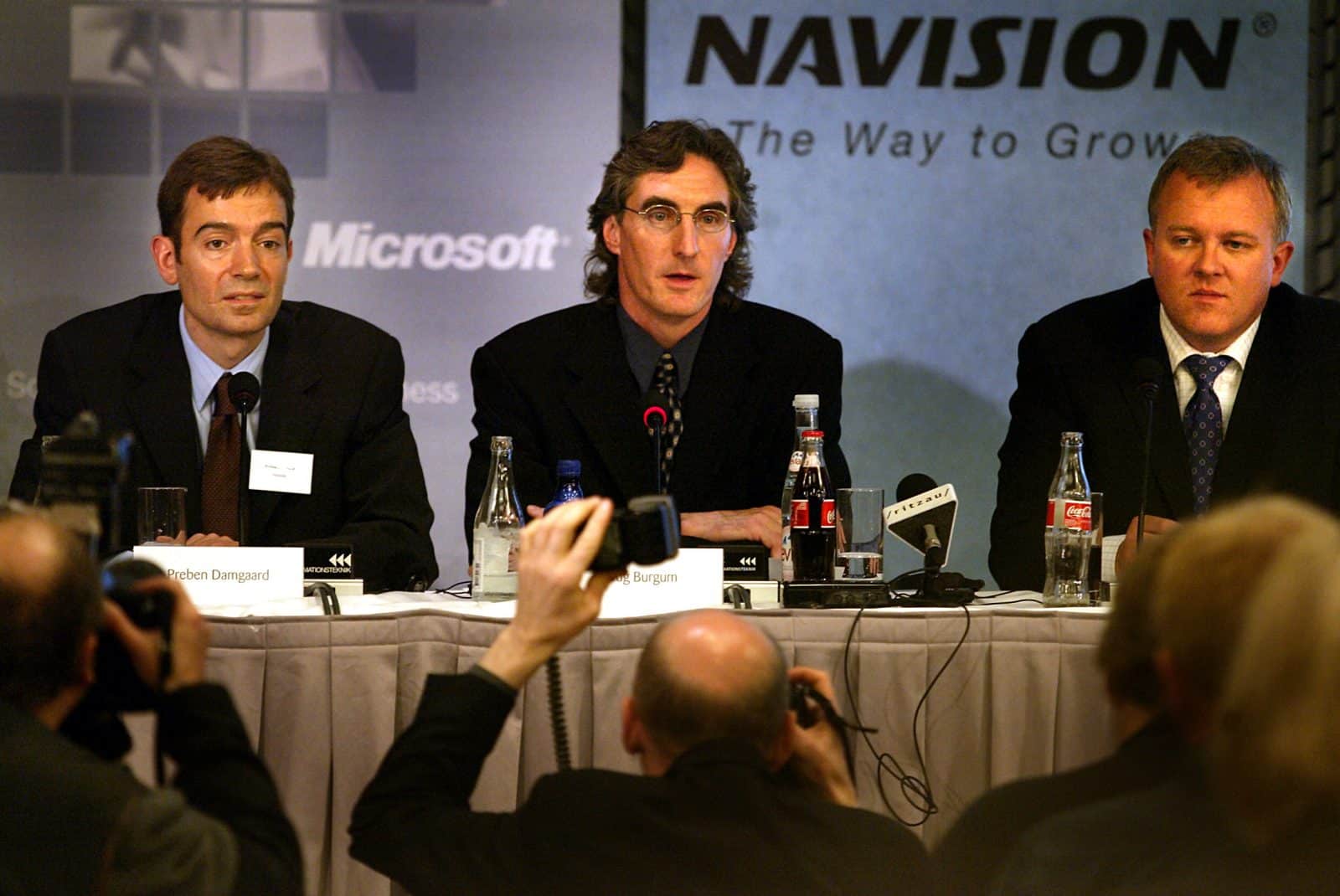 Doug Burgum (im), Microsoft senior vice president, er flankeret af to af softwareselskabet Navisons hovedaktionaerer Preben Damgaard(tv) og Jesper Balser(th) på et pressemøde tirsdag maj 7, 2002 i København, hvor det blev meddelt, at Microsoft køber Navision.SE RITZAU (Foto: BJARKE ØRSTED/SCANPIX NORDFOTO 2002)